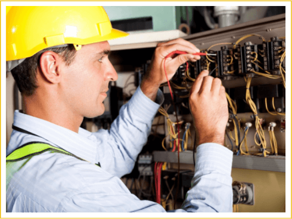 Male professional electrician testing industrial machine